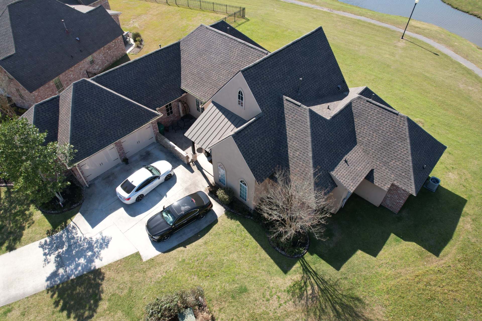 Aerial view of a gray shingle roof on a large Baton Rouge home