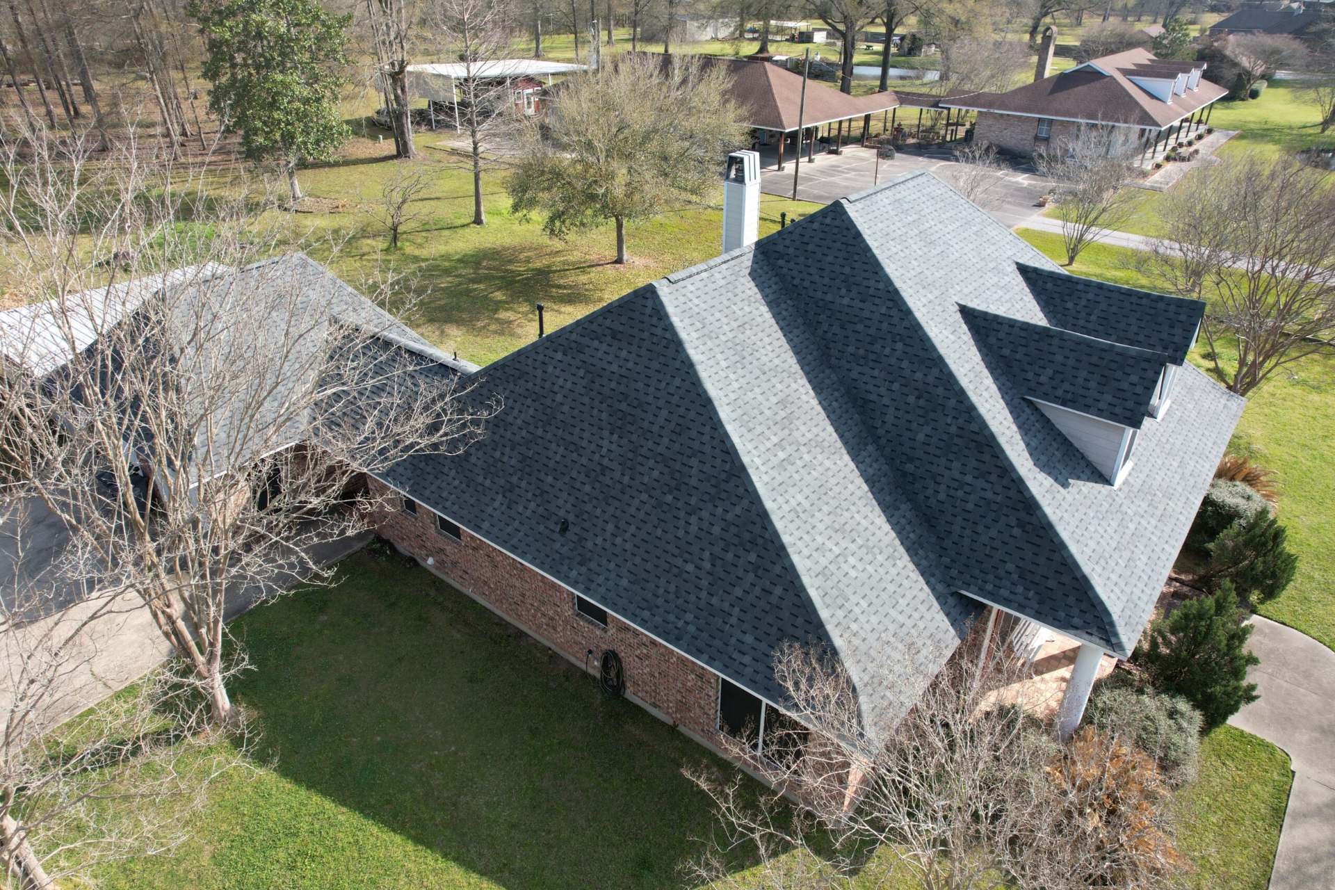 Aerial view of a new shingle roof in a Baton Rouge neighborhood