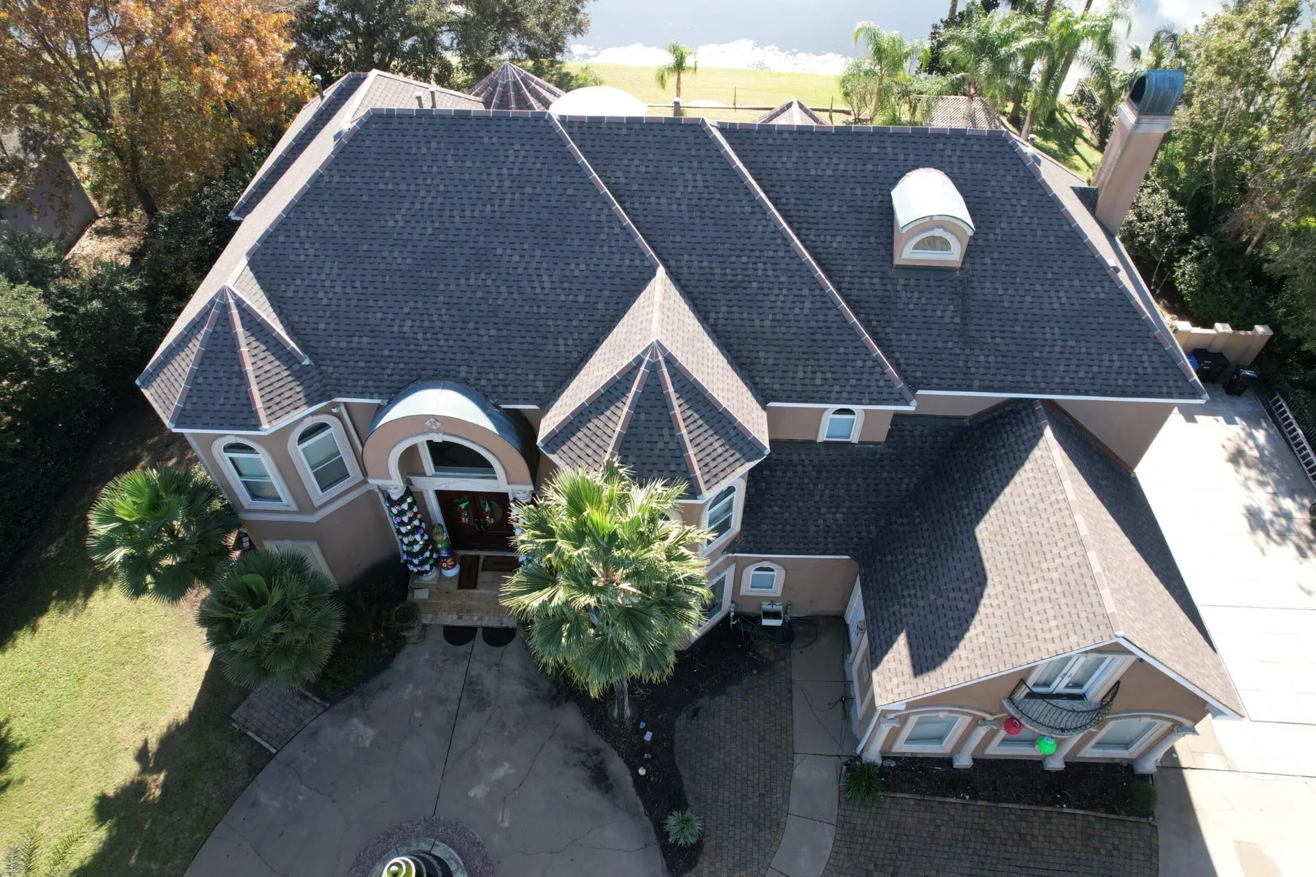 Aerial view of a new shingle roof on a brick home near Baton Rouge